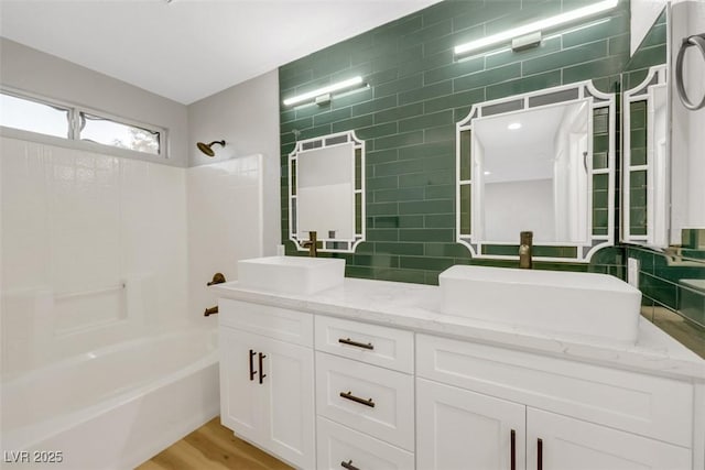 bathroom featuring shower / bathing tub combination, vanity, and wood-type flooring