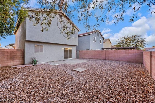 back of house with a patio