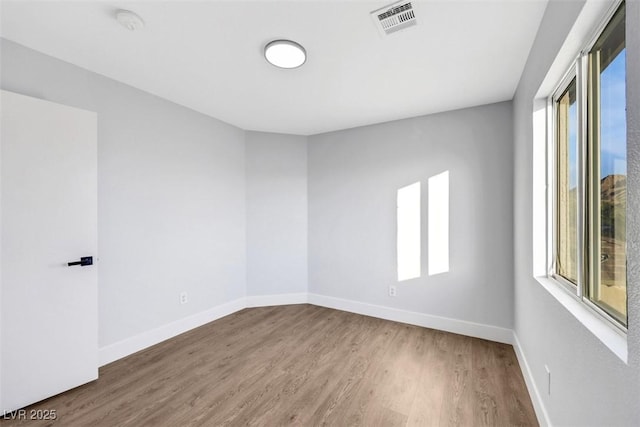 unfurnished room featuring hardwood / wood-style floors