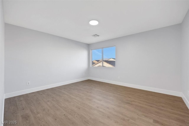 empty room with wood-type flooring