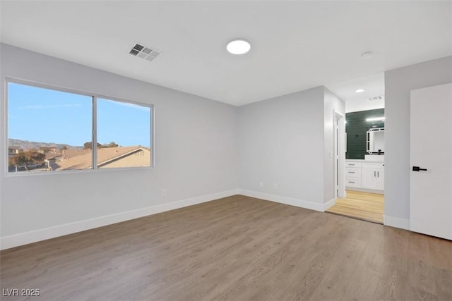 empty room with hardwood / wood-style floors