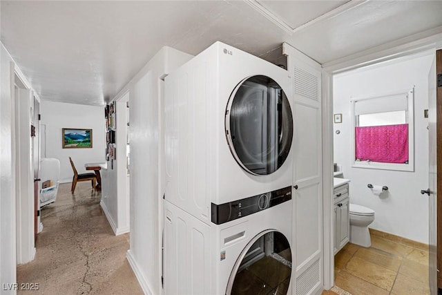 washroom with stacked washing maching and dryer