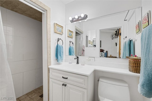 bathroom featuring toilet, a shower with curtain, tile walls, vanity, and tile patterned flooring