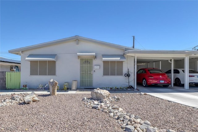 single story home featuring a carport