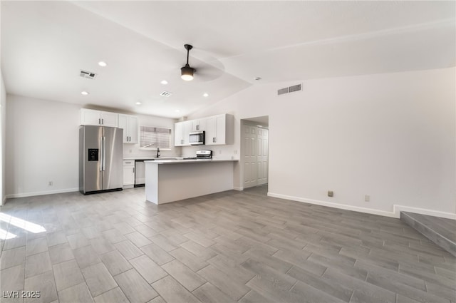 kitchen with appliances with stainless steel finishes, open floor plan, visible vents, and ceiling fan