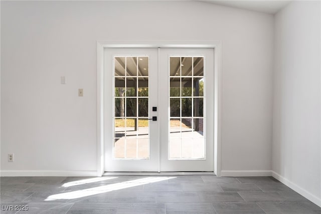 doorway featuring french doors and baseboards