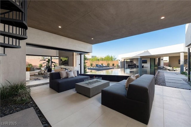 view of patio / terrace featuring an outdoor living space with a fire pit