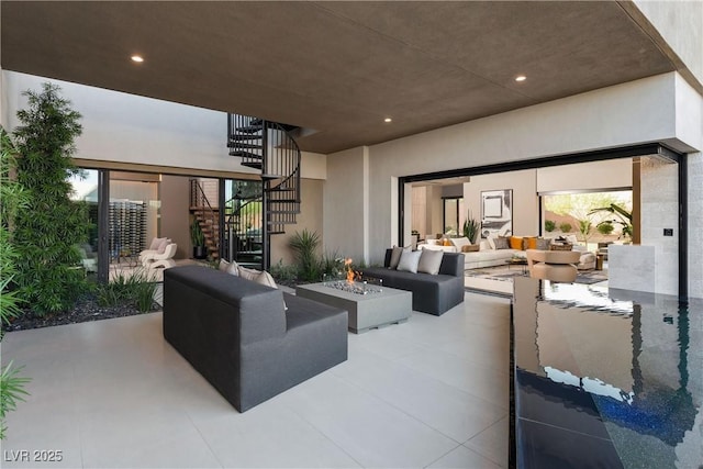 view of patio / terrace featuring an outdoor living space with a fire pit