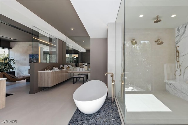 bathroom with vanity and independent shower and bath