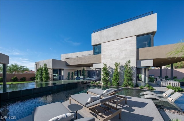 view of pool featuring a water view and a patio