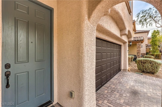 doorway to property featuring a garage