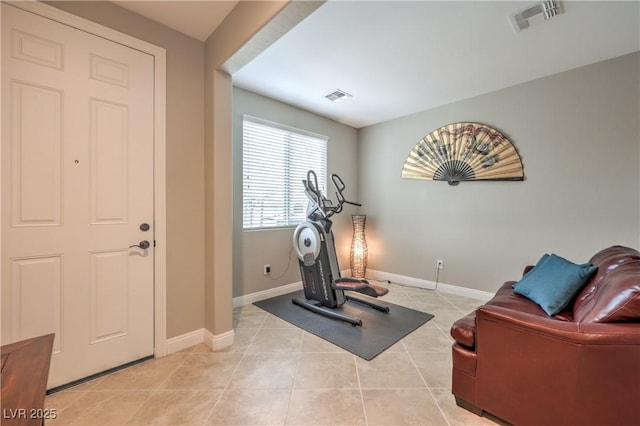 exercise area featuring light tile patterned flooring