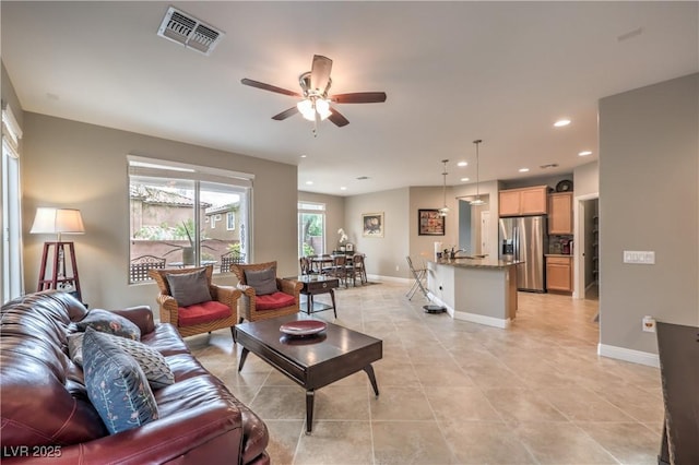 living room with ceiling fan and light tile patterned floors