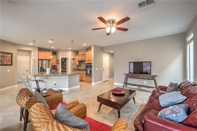 tiled living room featuring sink and ceiling fan