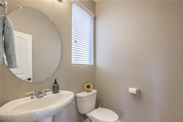 bathroom featuring toilet and sink