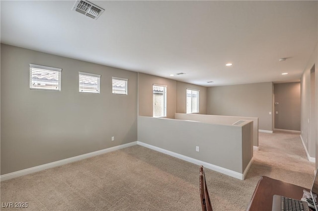 spare room featuring light colored carpet