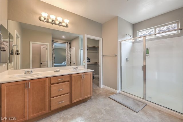 bathroom featuring tile patterned floors, vanity, and an enclosed shower