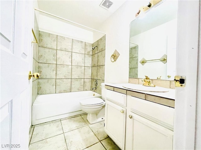 full bathroom with tiled shower / bath combo, vanity, tile patterned floors, and toilet