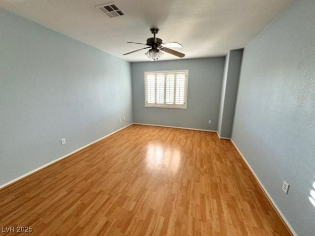 empty room featuring ceiling fan and light hardwood / wood-style floors