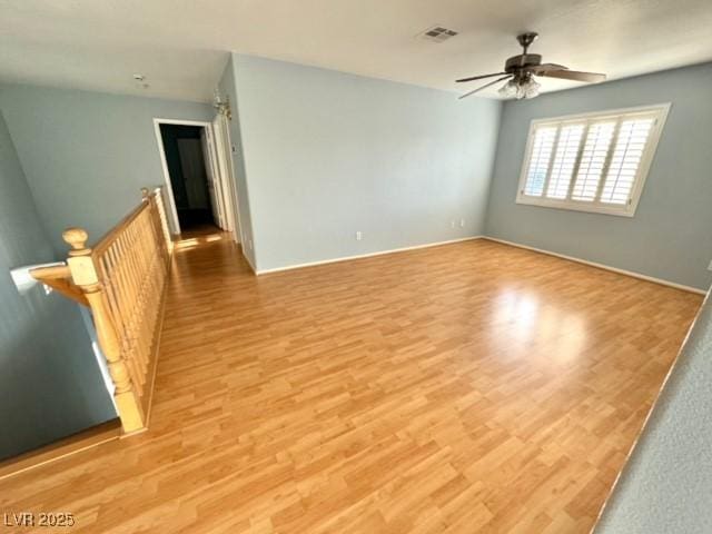 spare room featuring light hardwood / wood-style flooring and ceiling fan