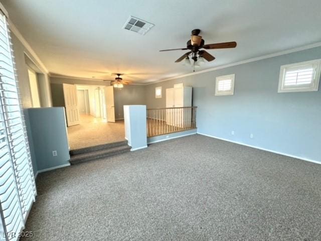 carpeted empty room featuring ceiling fan and ornamental molding