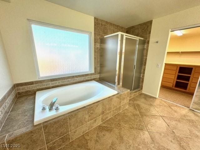 bathroom featuring tile patterned floors and separate shower and tub