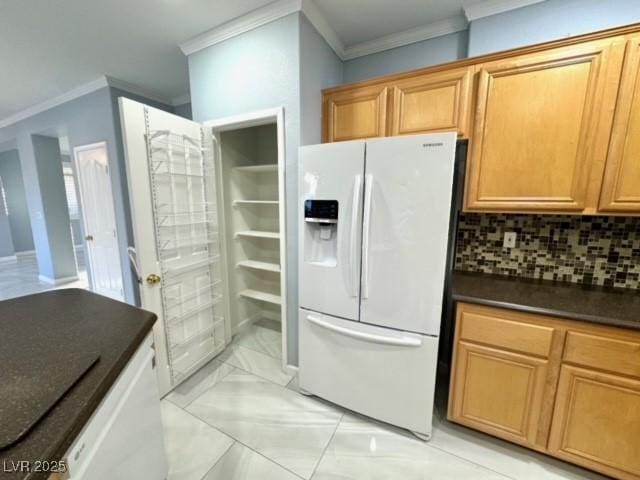 kitchen featuring crown molding, white fridge with ice dispenser, and decorative backsplash