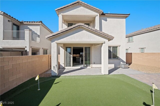 rear view of property featuring a patio area