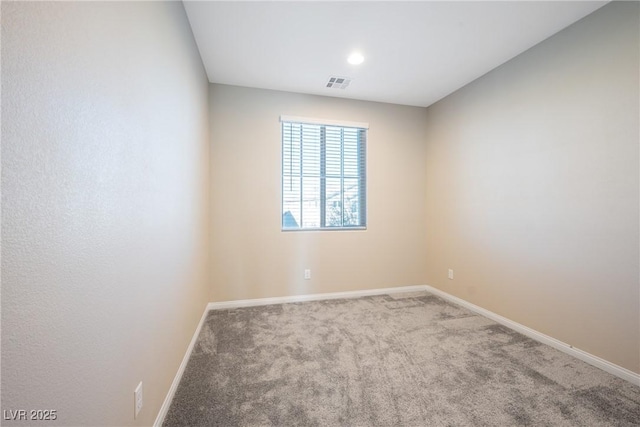 empty room with baseboards, visible vents, and carpet flooring