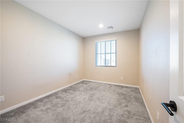 carpeted empty room with visible vents and baseboards