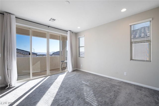 empty room featuring recessed lighting, carpet flooring, visible vents, and baseboards