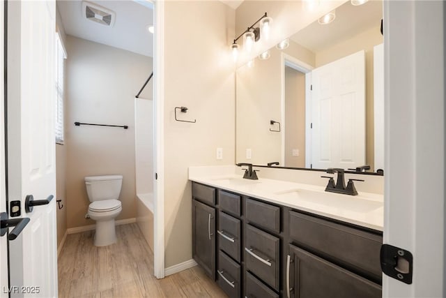 full bath with toilet, shower / bath combination, a sink, visible vents, and double vanity