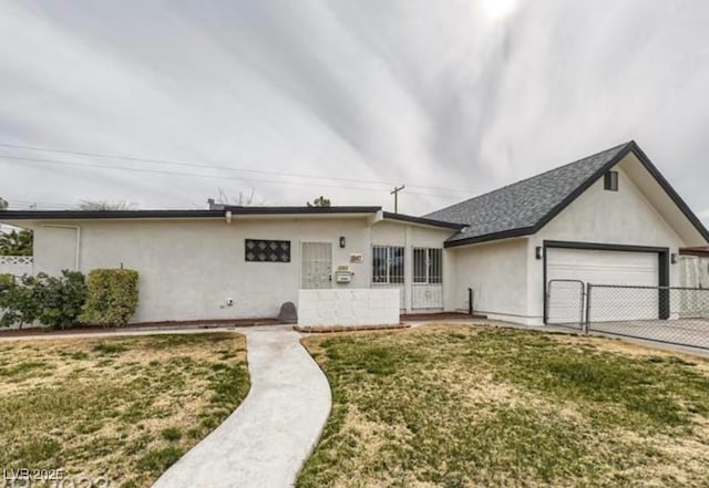 ranch-style house featuring a garage and a front yard