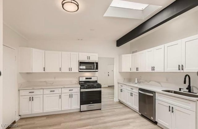 kitchen featuring white cabinetry, sink, and stainless steel appliances