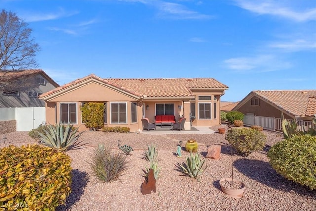 rear view of property featuring outdoor lounge area and a patio area