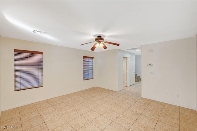 unfurnished room featuring light tile patterned floors and ceiling fan