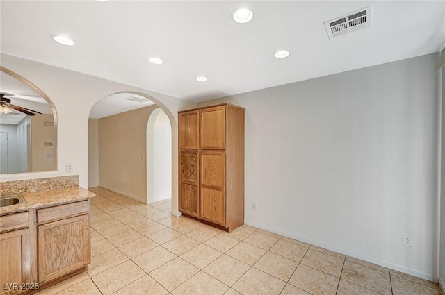 kitchen featuring sink, light tile patterned floors, and ceiling fan