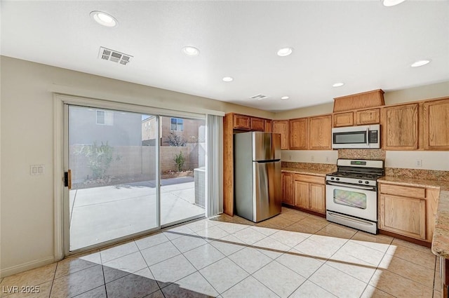 kitchen with light tile patterned flooring and appliances with stainless steel finishes