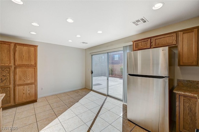 kitchen featuring stainless steel fridge and light tile patterned floors