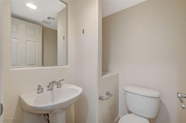 bathroom featuring toilet and sink