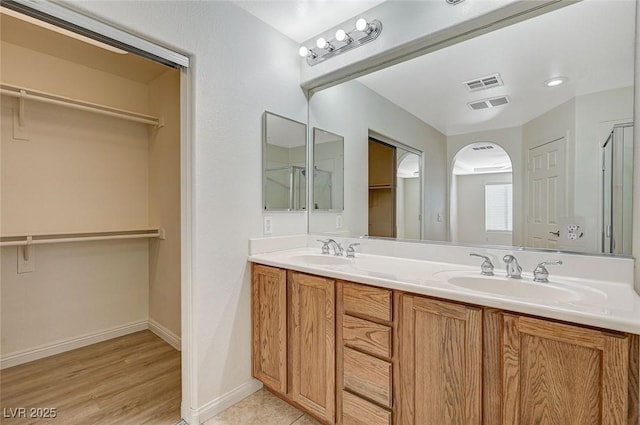 bathroom with vanity and wood-type flooring