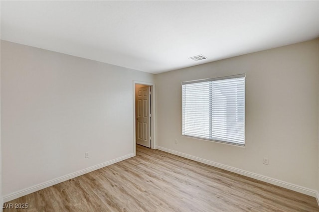 unfurnished room with light hardwood / wood-style flooring