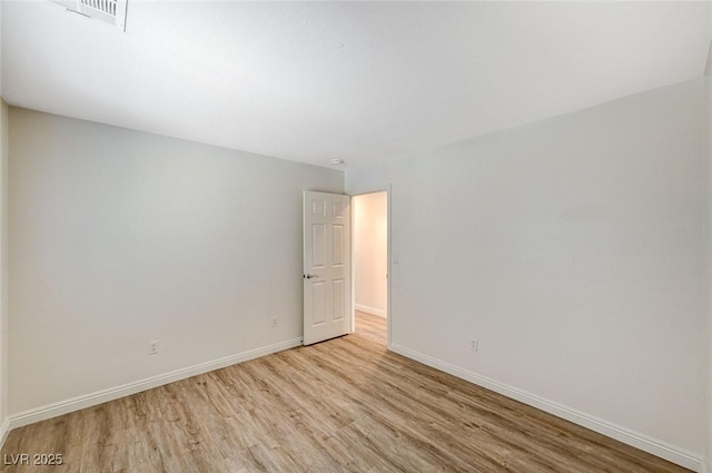 spare room featuring light hardwood / wood-style flooring