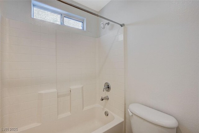 bathroom with toilet and  shower combination