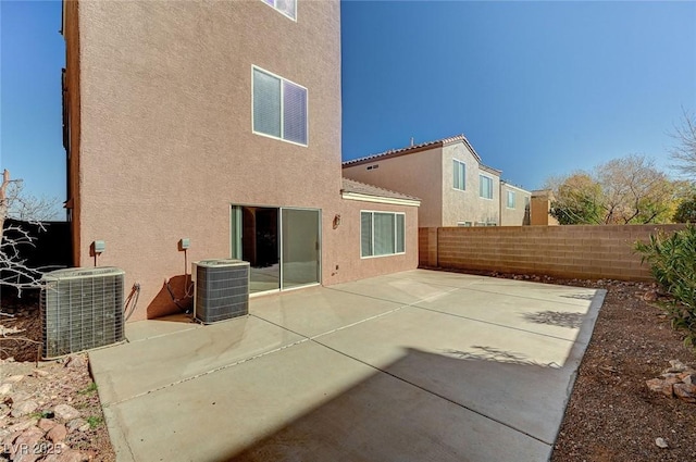 rear view of property featuring cooling unit and a patio area