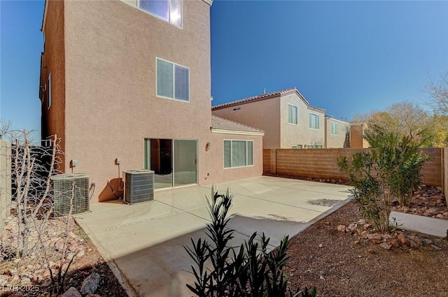 back of house featuring cooling unit and a patio area