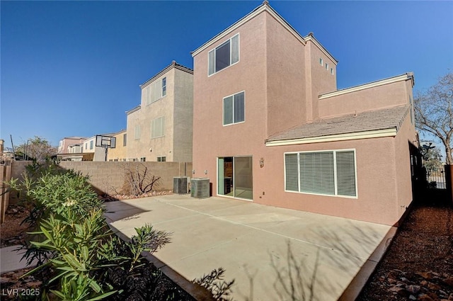 rear view of house with a patio area and central air condition unit