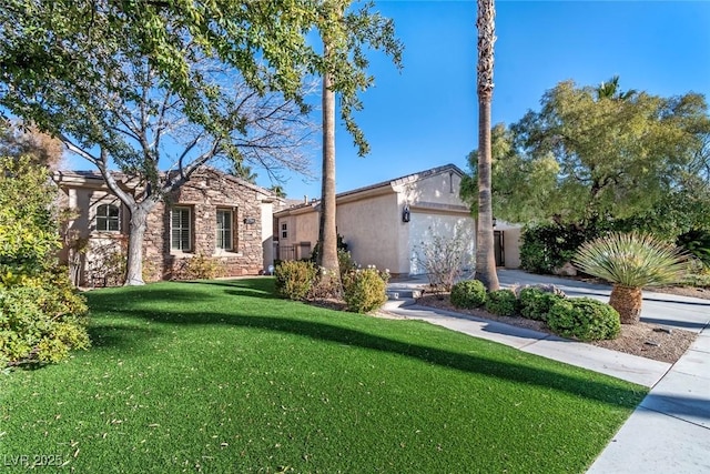 view of front of home with a front yard, stone siding, an attached garage, and stucco siding