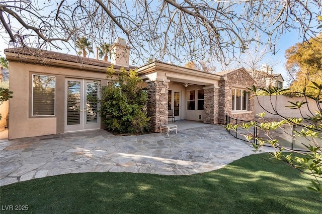 back of property featuring french doors, a patio, stucco siding, ceiling fan, and stone siding