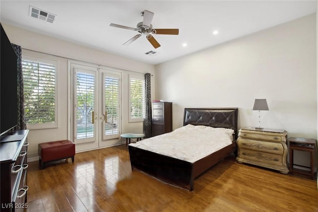 bedroom featuring access to exterior, a ceiling fan, visible vents, and wood finished floors